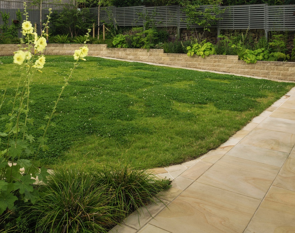 Family garden with large lawn and stepped raised beds.