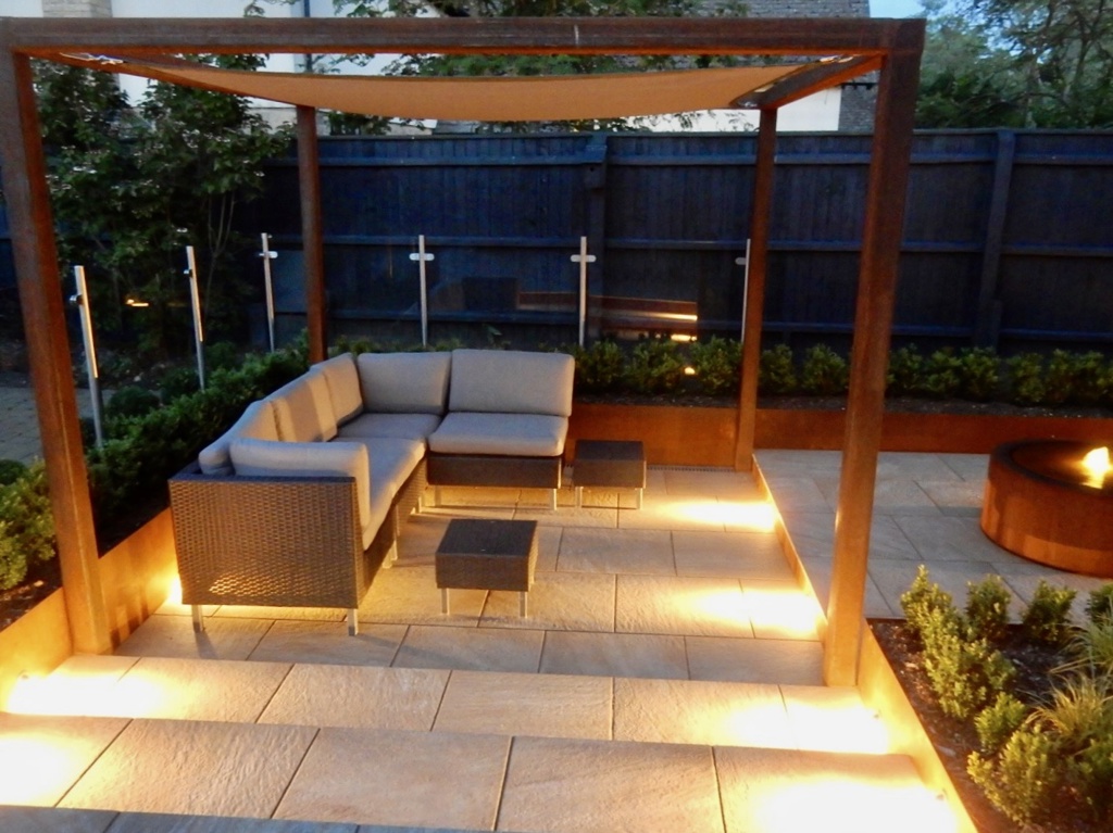 A contemporary garden with water and lighting