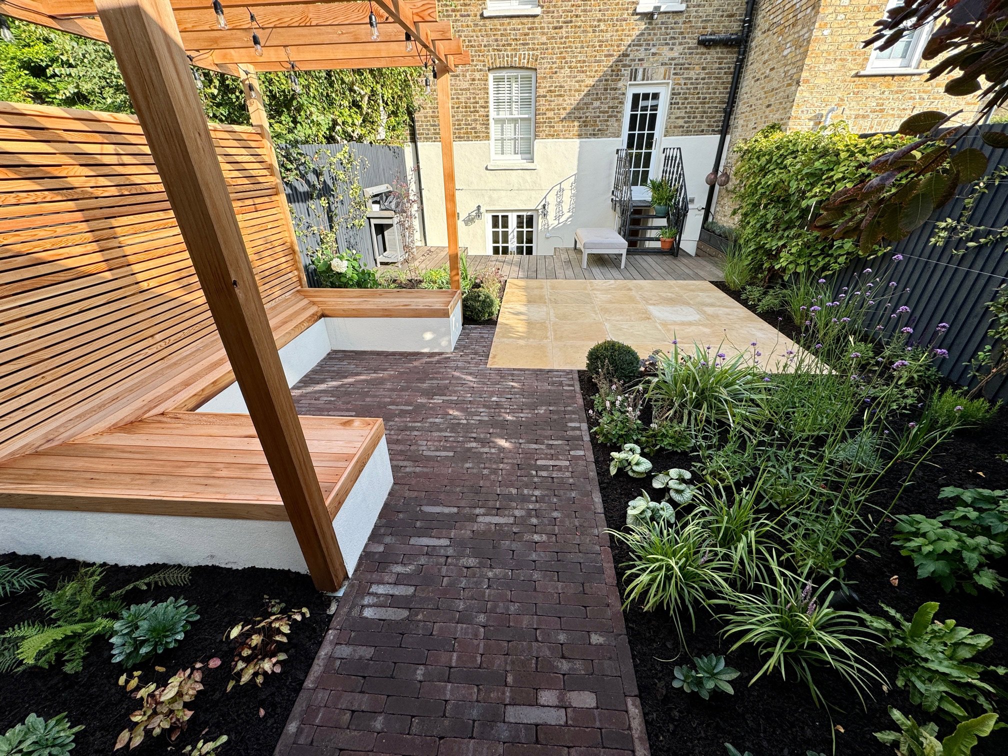 Clay paver path and cedar pergola