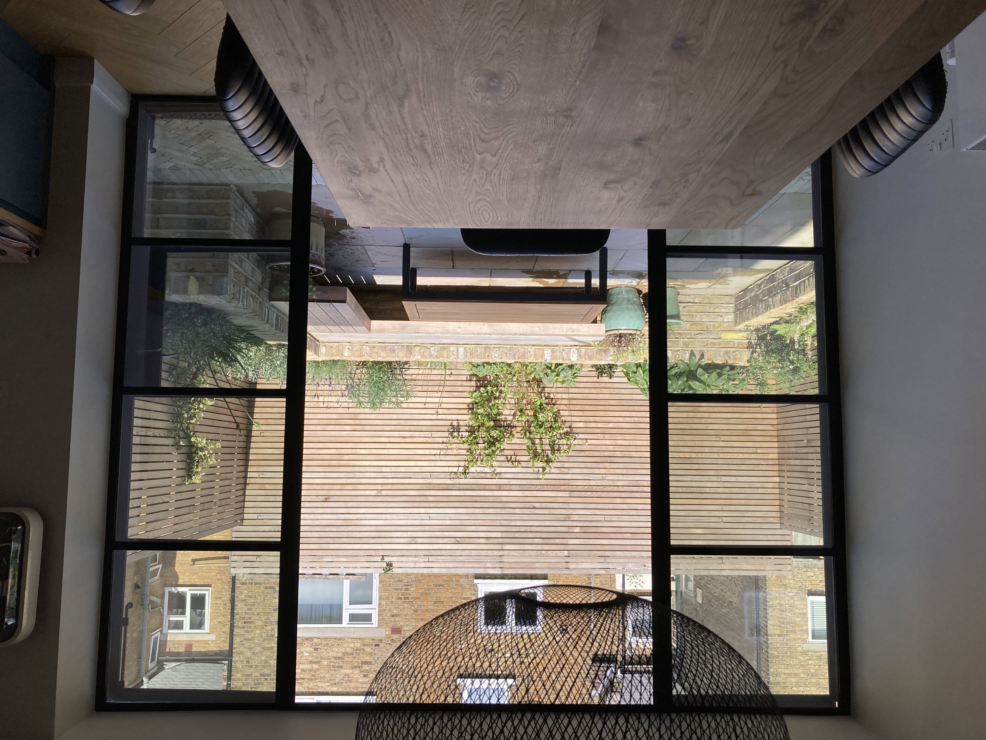 View out to courtyard from kitchen through crittall doors