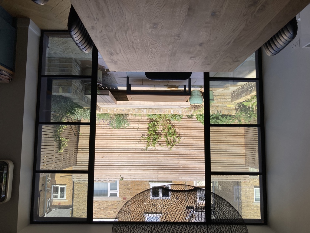 View out to courtyard from kitchen through crittall doors