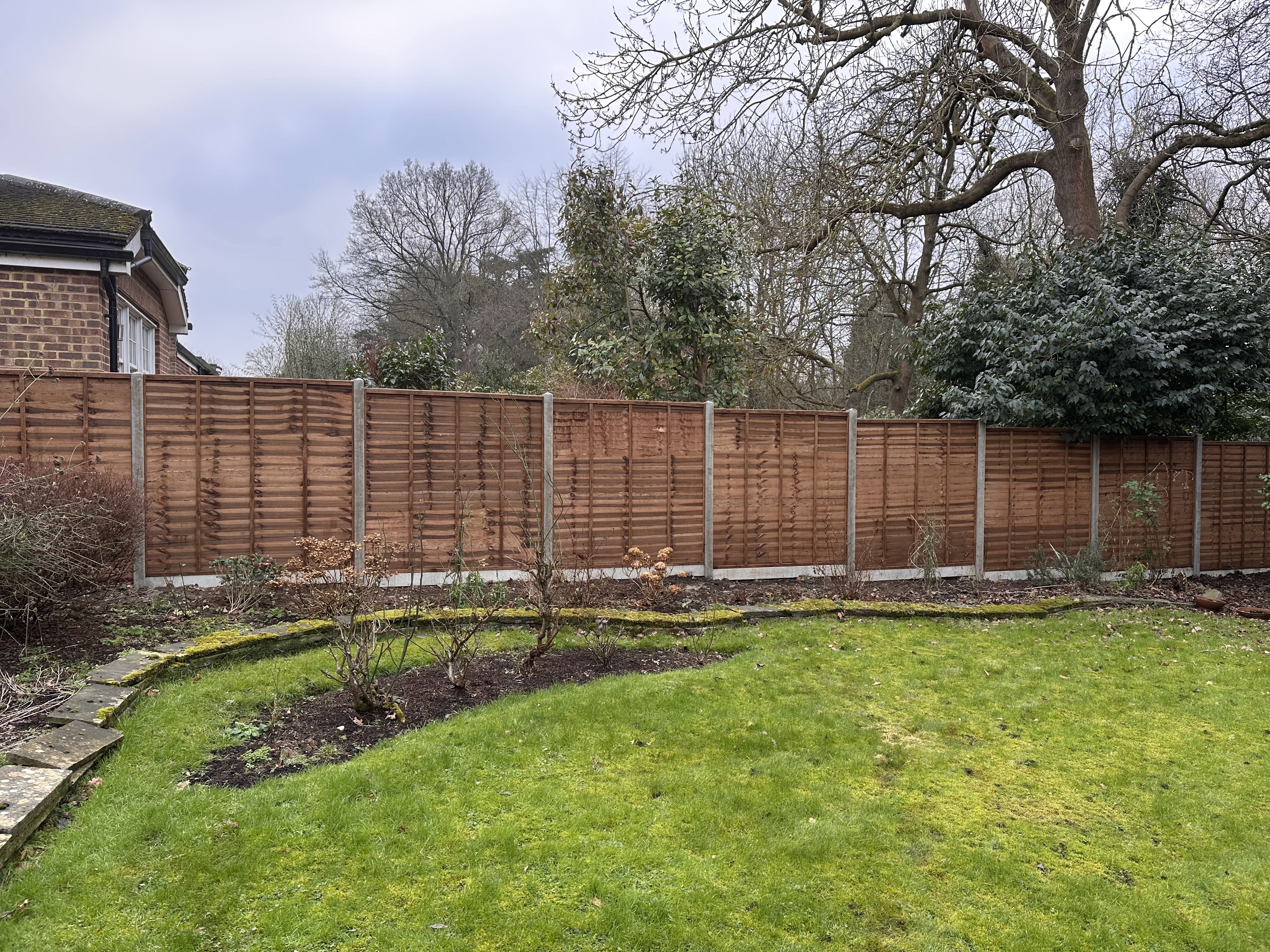 Overlap fencing Installation, side elevation, concrete posts and kickboards boards boards, overlap panelling.