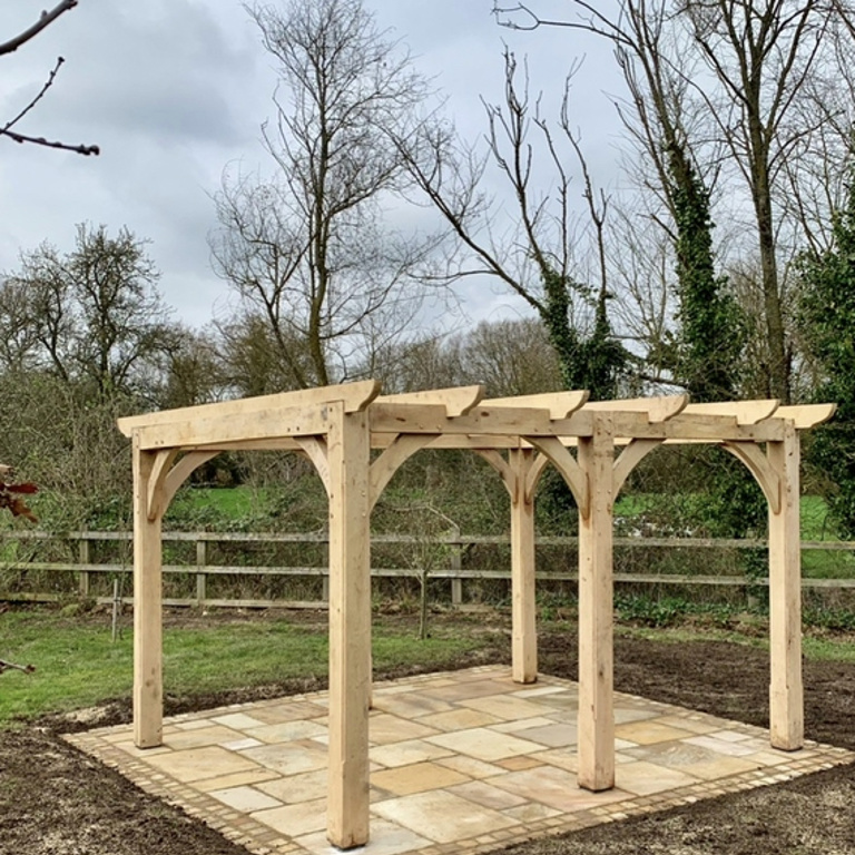 oak pergola and sandstone patio