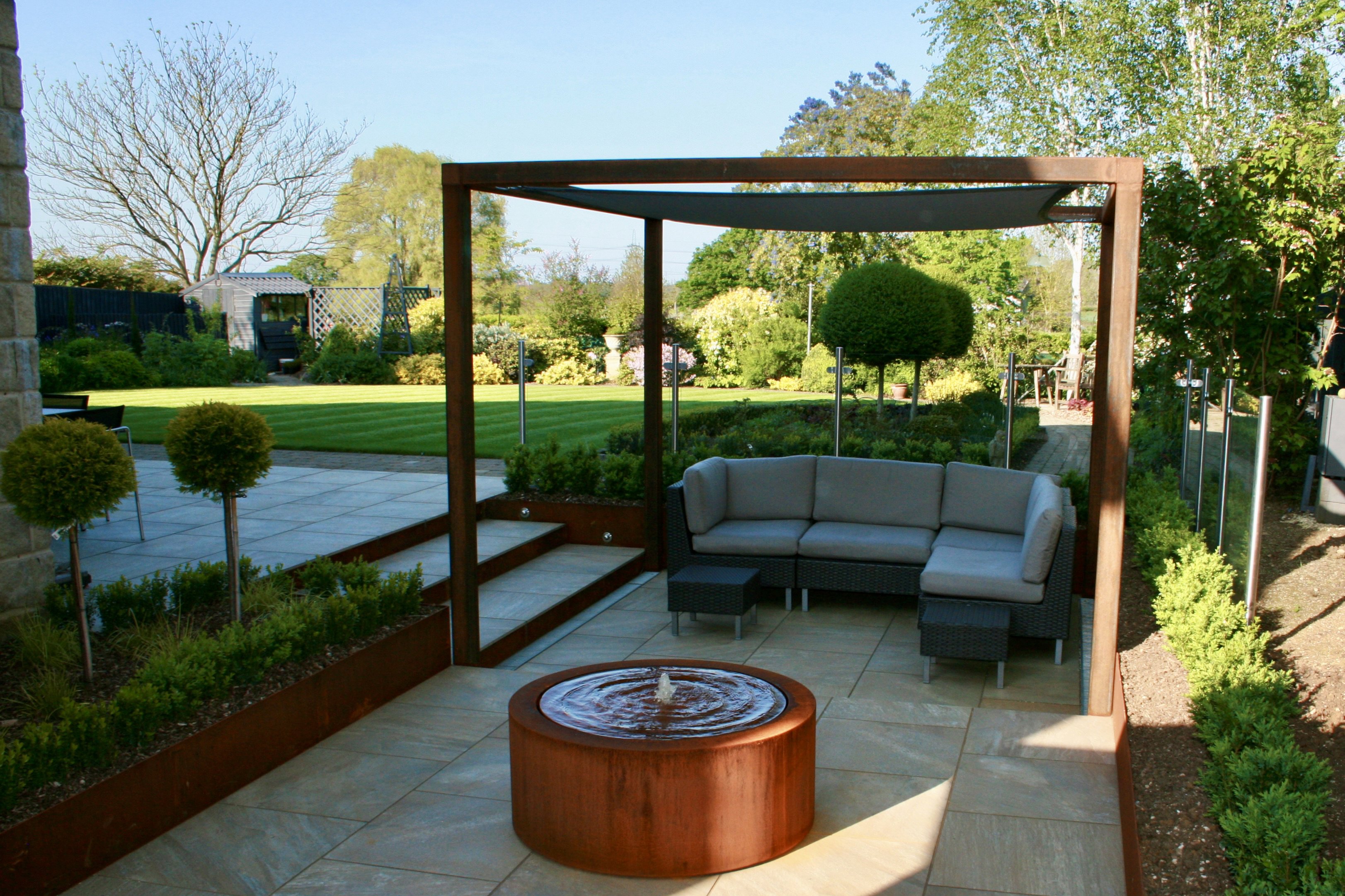 A contemporary garden with water and lighting