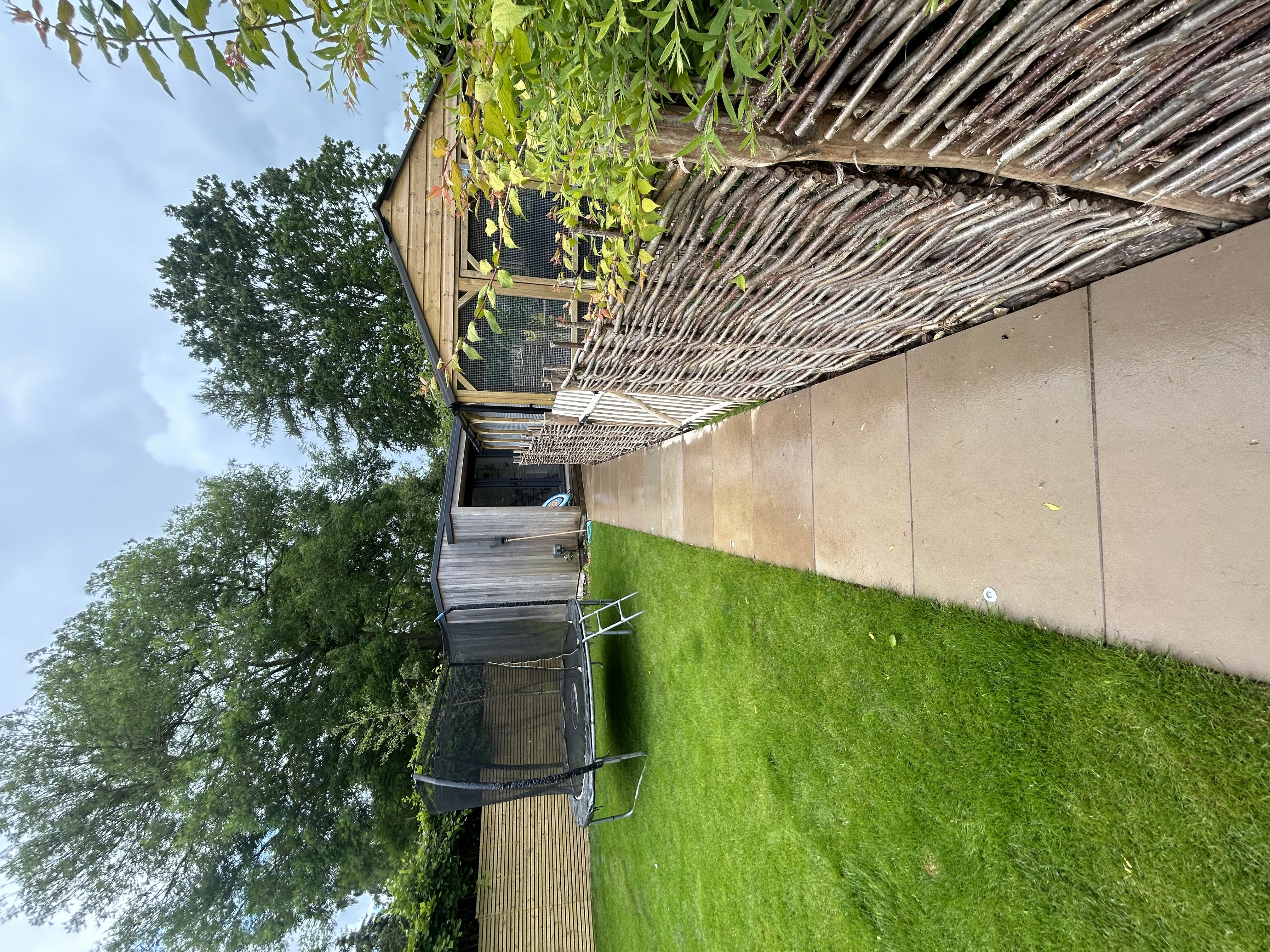 Wonen hazel fencing, path with inset lighting, formal lawn and garden studio 