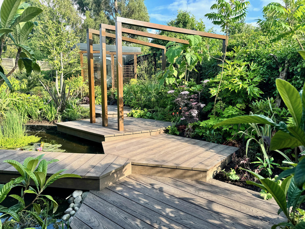 Multi-level decks leading up the garden through exotic planting
