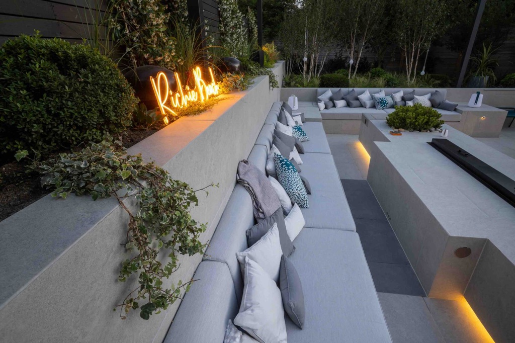 Close up on seating area, overhanging plants and planika fire place